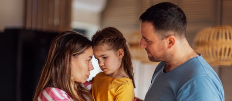 Parents comforting sad daughter