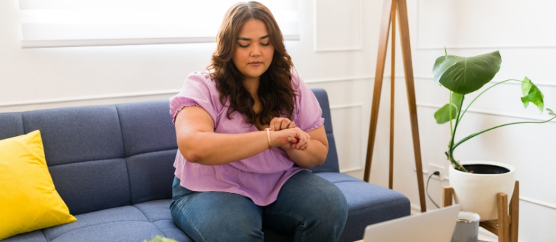 Young woman looking at her watch
