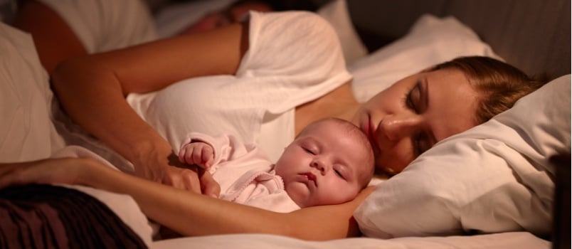 Mother sleeping with kid 