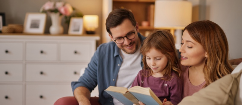 family reading book together 