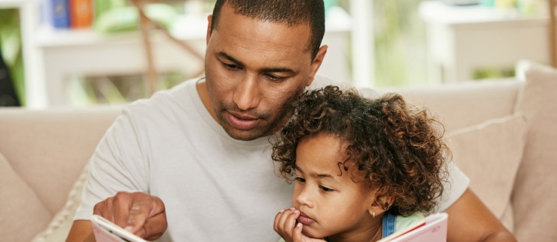 Daughter and father reading book