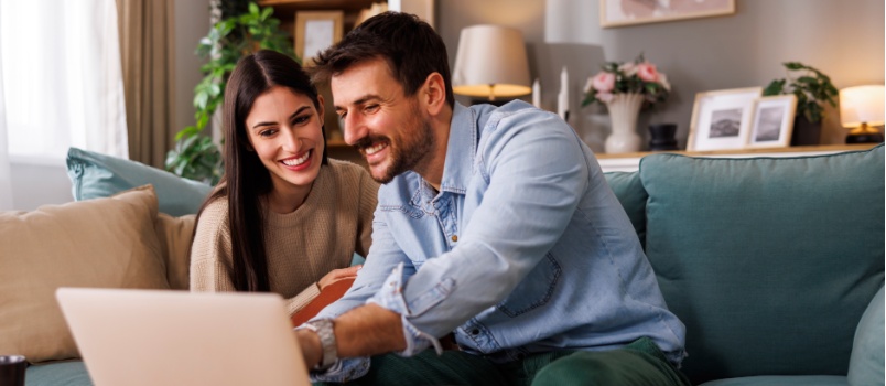 Young loving couple using laptop