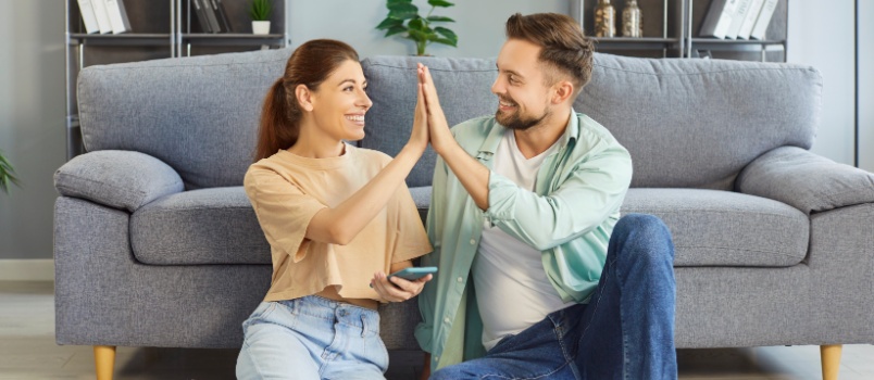 Couple smilling sitting on floor