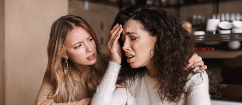 Young girl comforting friend