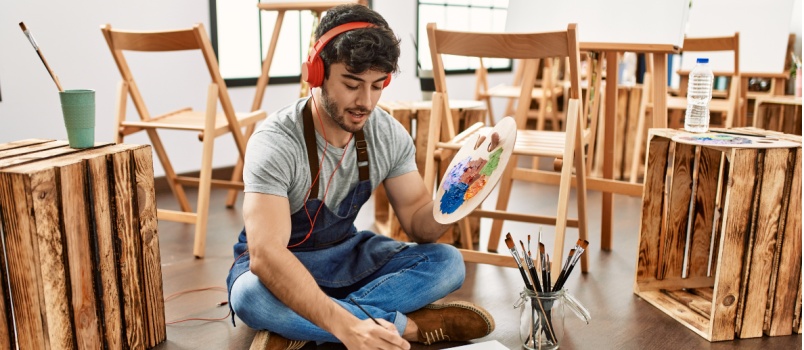 Artistic man smiling while painting