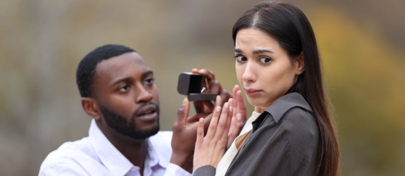 Man proposing woman while she is refusing