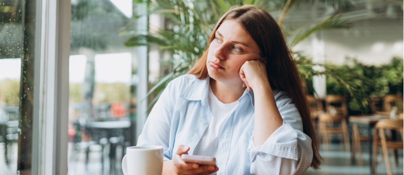 Sad young woman sitting alone