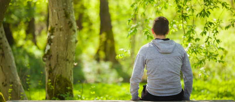 Young man sitting on bench