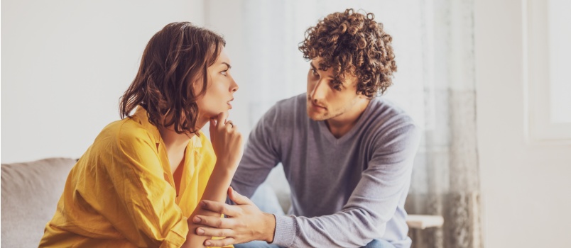 Sad man and woman siting on couch