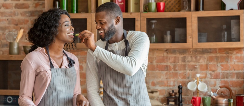 Young man feeding his wife
