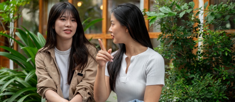 Two female friend talking to each other