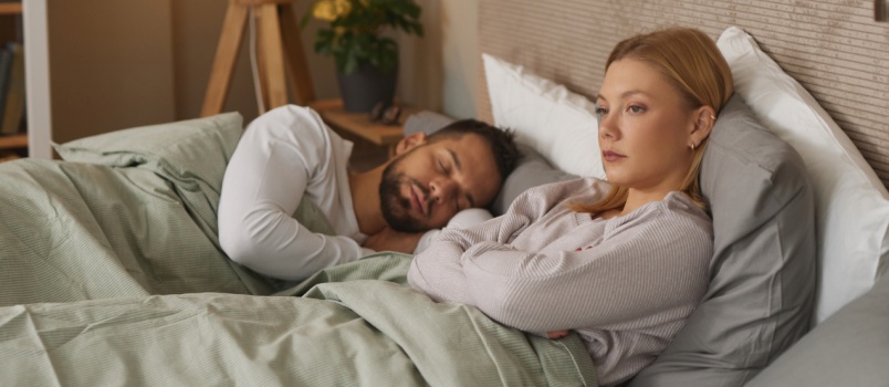Woman sitting on bed