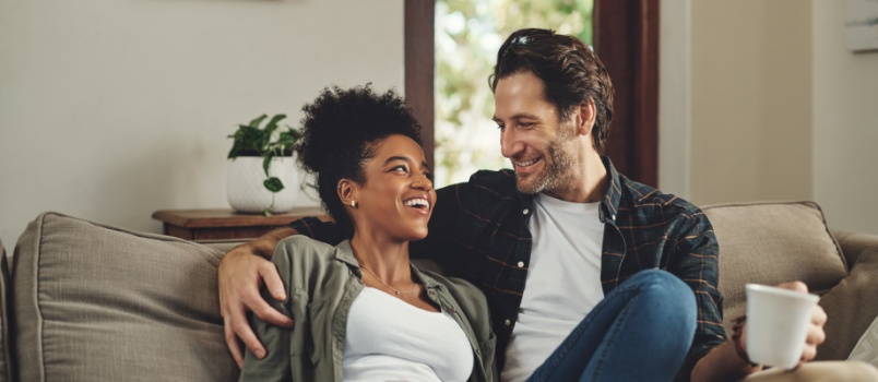 Young loving couple sitting on couch