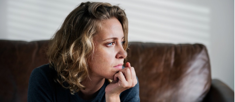 Thoughtful woman sitting alone