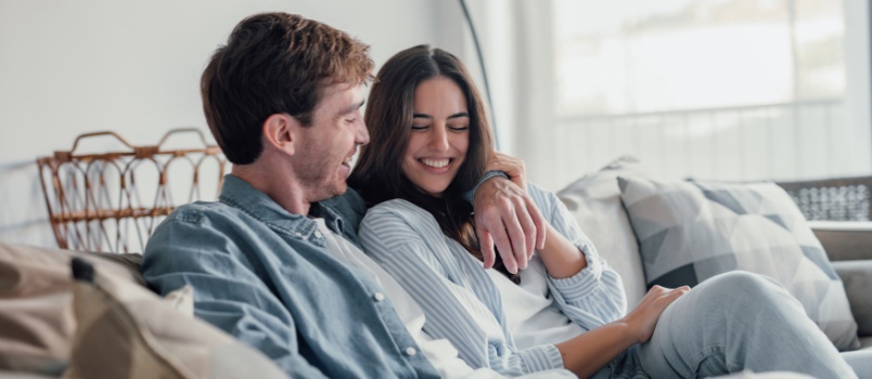 Young loving couple sitting on couch