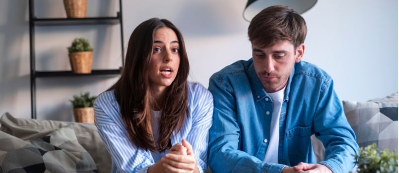 Couple sitting on couch having problems