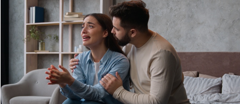 Man comforting sad woman