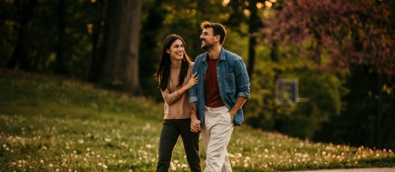 Young couple walking in park