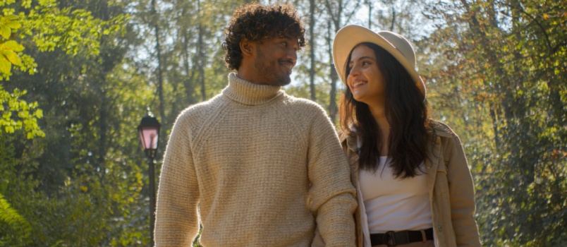 Young loving couple walking in park