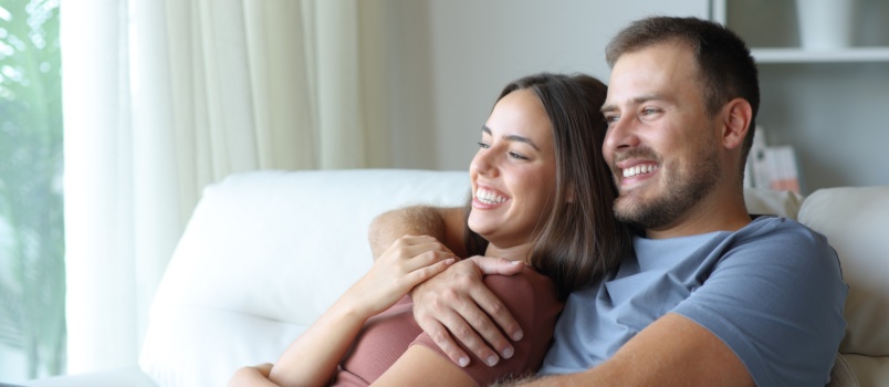 Happy couple relaxing on couch