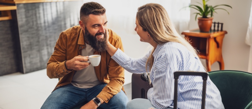 Couple having coffee sitting in hotel