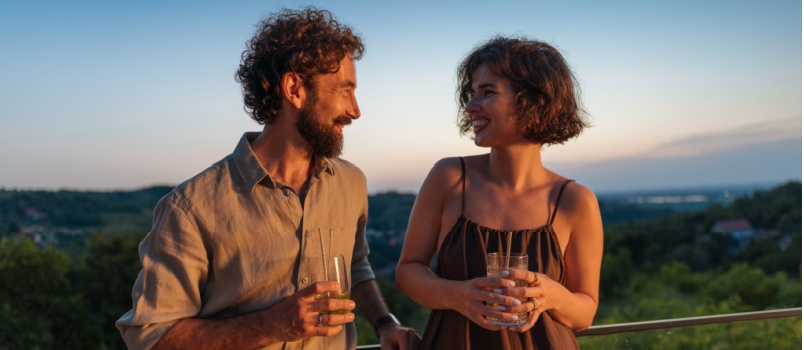 Couple holfding cocktails and enjoying romantic sightseeing
