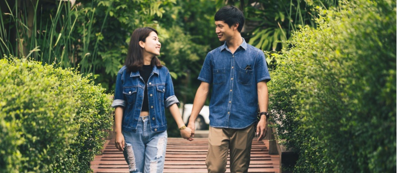 Young couple walking in park