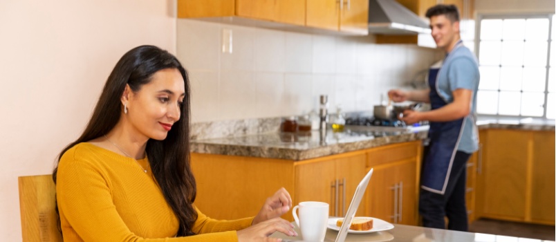 Woman working while husband cooking