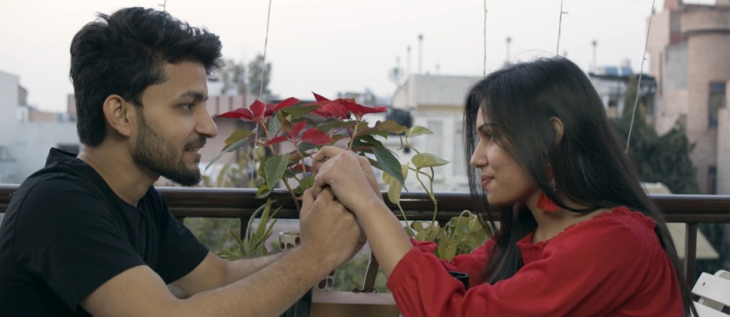 Couple sitting in cafe holding each other hand