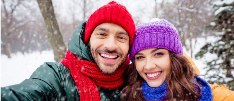 Young couple taking selfie enjoying in snow 