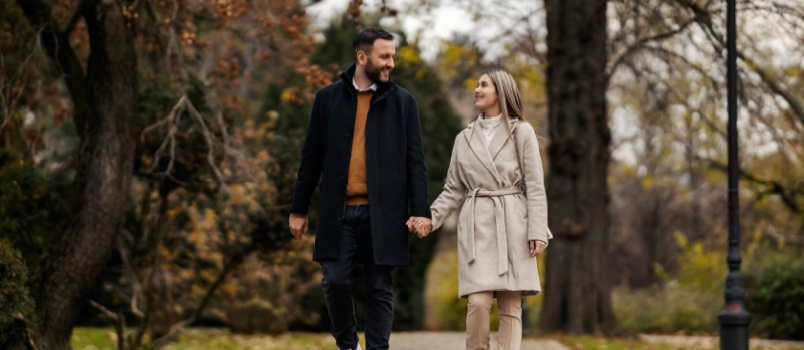 Young couple walking in park