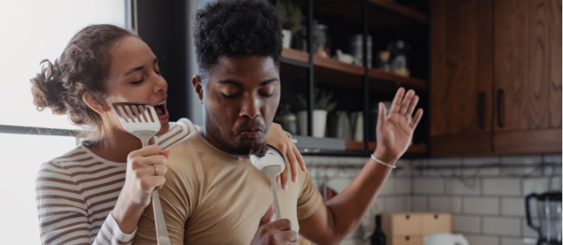 Playful couple cooking together