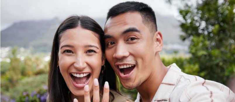 Newly engaged couple showing wedding ring