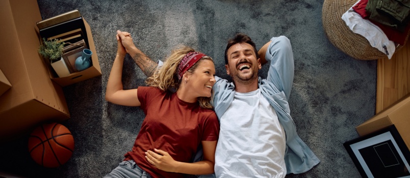 Cheerful couple layinhg on floor 