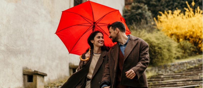 Young couple holding hand walking in street
