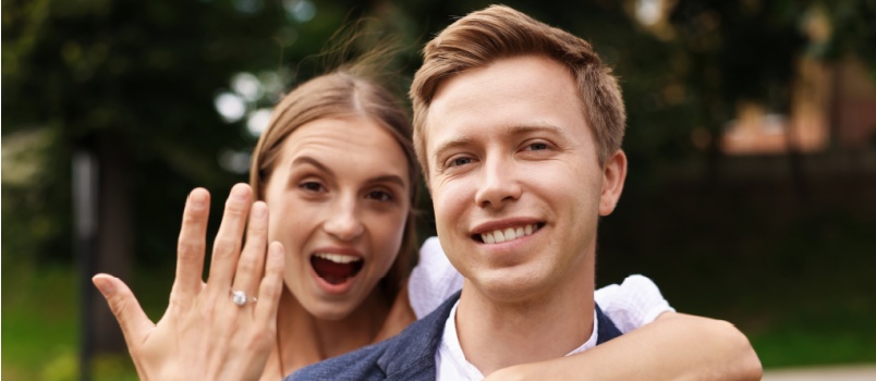 Newly engaged couple showing ring