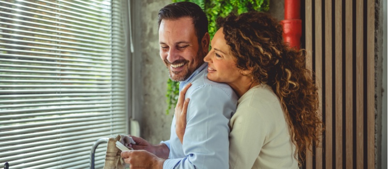 Young happy coulple working in kitchen together