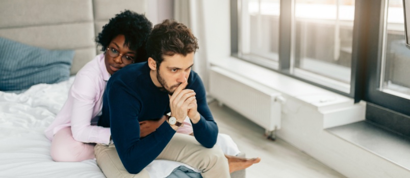 Woman comforting man