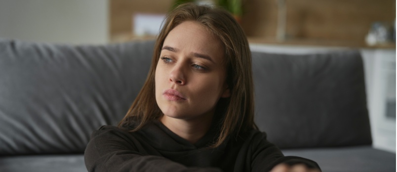 Sad woman sitting on the floor