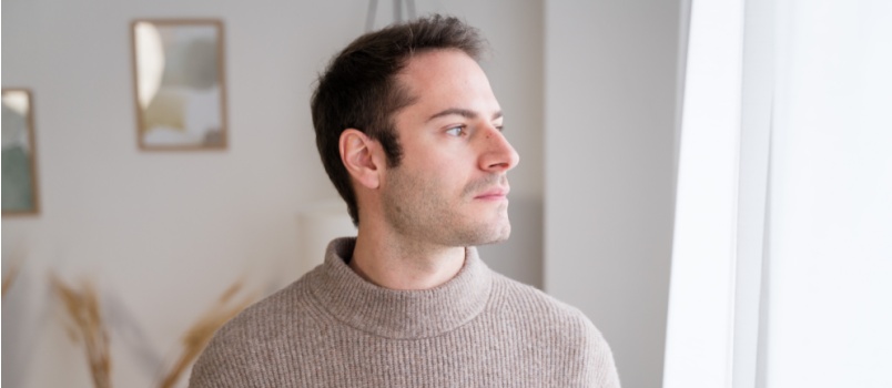 Man looking outside window