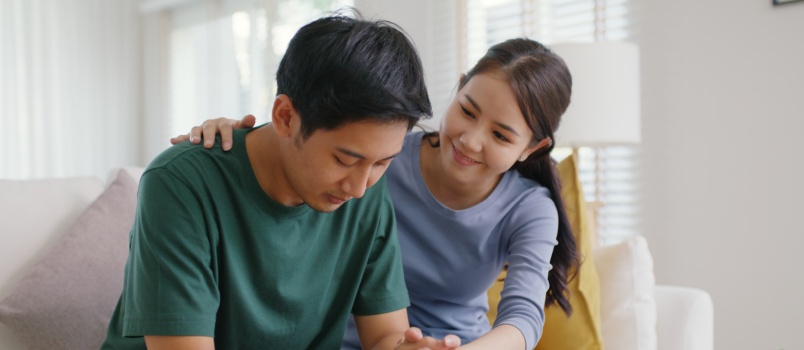 Woman comforting man