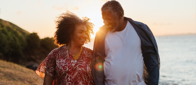 young loving couple walking on beach