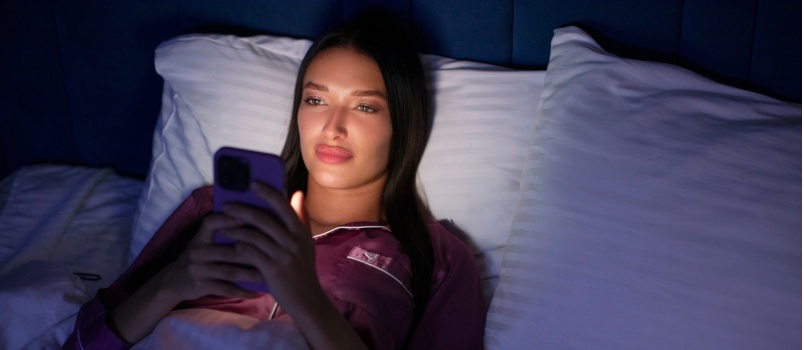 Young beautiful woman using phone in night