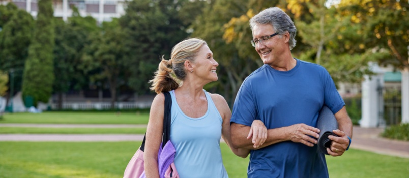 Smiling elderly couple walking together in park