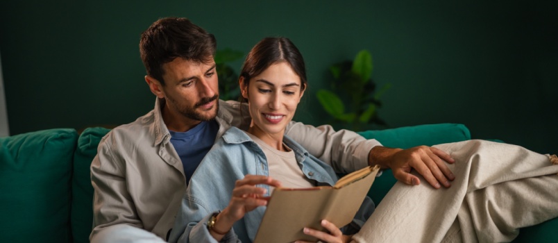 Young couple reading book together