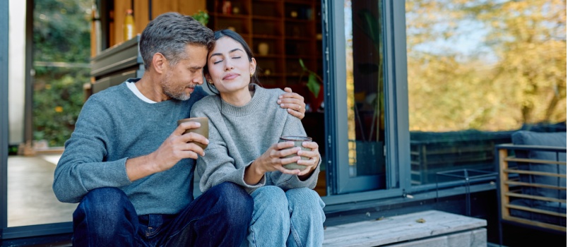 Young couple sitting outside having coffee