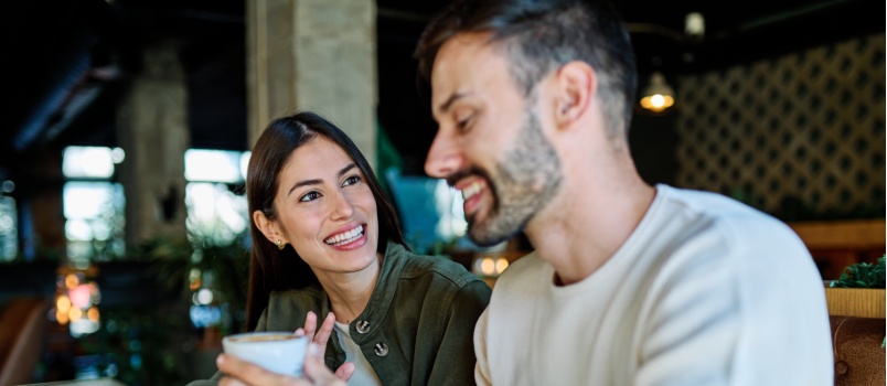 Young couple enjoying coffee over conversation
