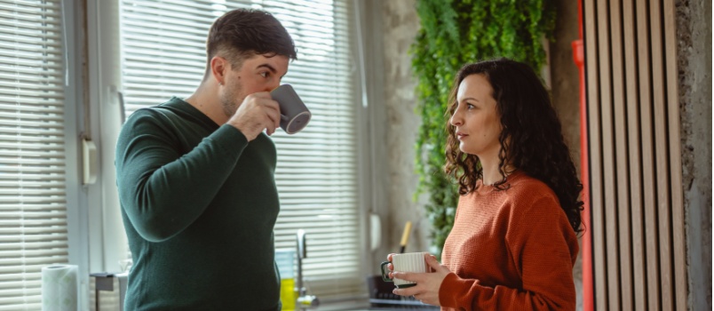 Young couple having coffee in kitchen