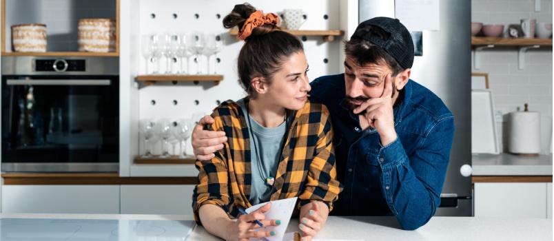 Couple standing in kitchen