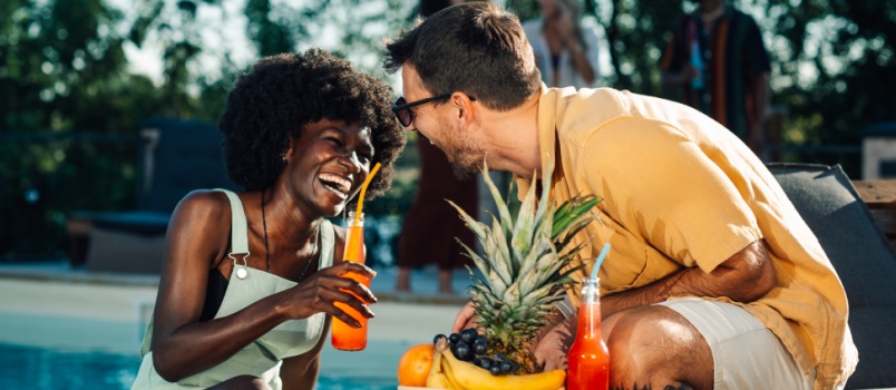 Couple enjoying poolside breakfast